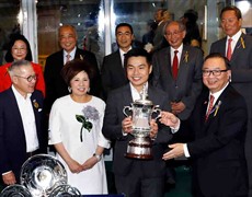 The Hon Martin Liao (front row, 1st from right), Steward of the Club, presents the winning trophy and silver dishes to Owner Patrick Kwok Ho Chuen and his family, Trainer John Moore and Jockey Derek Leung of Beauty Generation, winner of the Celebration Cup.