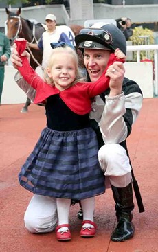 Zac Purton celebrates his treble, culminating in his win aboard Exultant, with daughter Roxy in the Sha Tin winners’ circle.