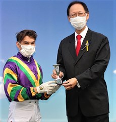 Philip Chen, Chairman of The Hong Kong Jockey Club, presents the HKSAR Chief Executive’s Cup Silver Dish to jockey Alexis Badel.