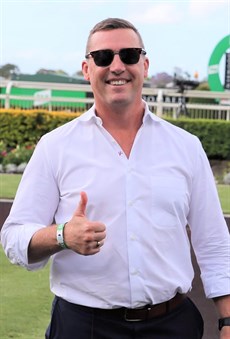 Tony Gollan celebrates saddling the first four runners past the post in a QTIC Three-Year-Old Handicap ...
