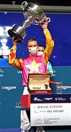 Zac Purton holds aloft the trophy after winning the 2020 Hong Kong Longines International Jockeys' Championship