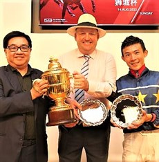Owner Mr Lim Siah Mong, trainer Daniel Meagher and jockey Wong Chin Chuen proudly present their trophies after Lim's Kosciuszko's triumph (pictured below) in the Group 1 Lion City Cup 