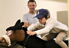 Now Cahill, pictured here watching his son Harry getting to it on the mechanical horse, will be bringing all of his expertise to a new role with the Racing Queensland Apprentice Education Program

Photos: Graham Potter, 